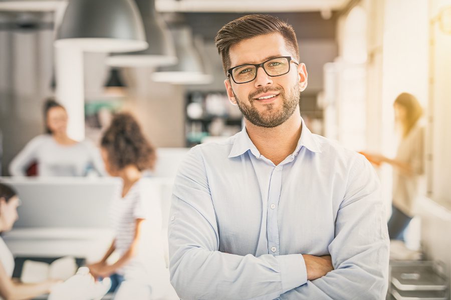 Business Insurance - Portrait of Man Standing in Front of His New Startup Business